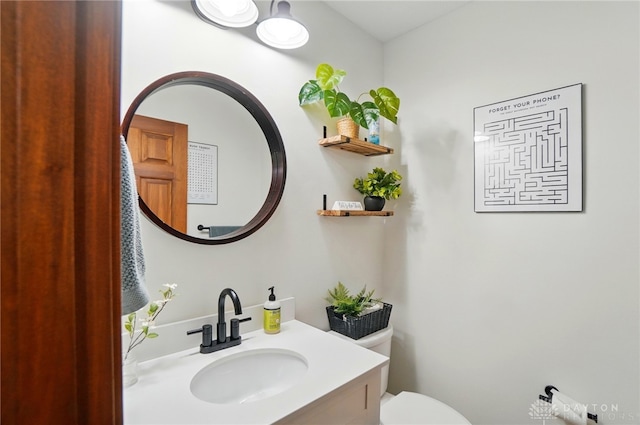bathroom featuring toilet and vanity