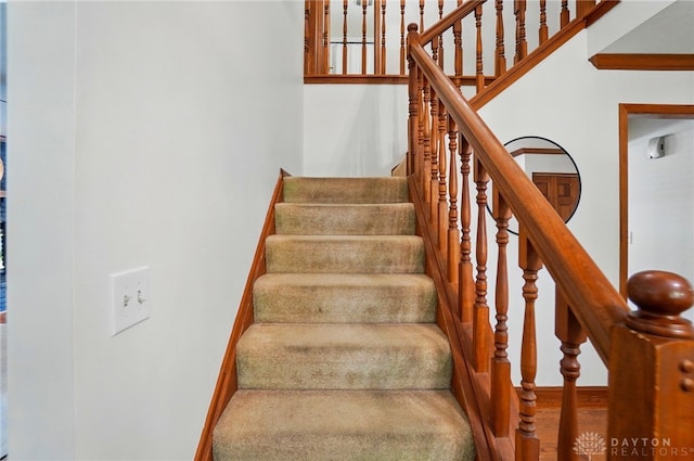 staircase featuring baseboards