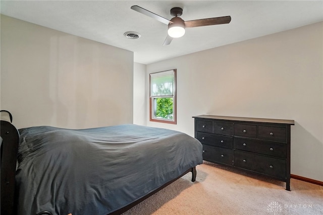bedroom with baseboards, ceiling fan, light carpet, and visible vents