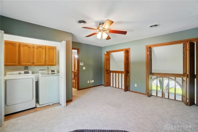 washroom with visible vents, cabinet space, ceiling fan, and washing machine and clothes dryer
