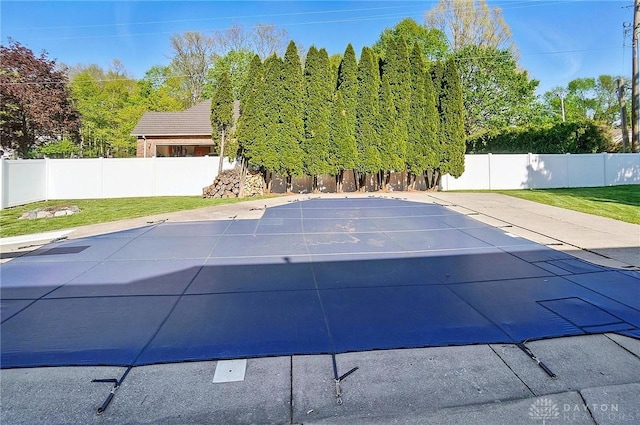 view of pool featuring fence and a yard