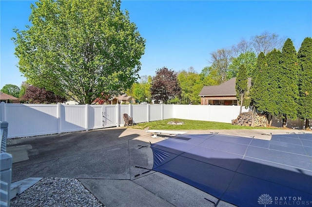 view of swimming pool featuring a patio, a fenced backyard, and a pool