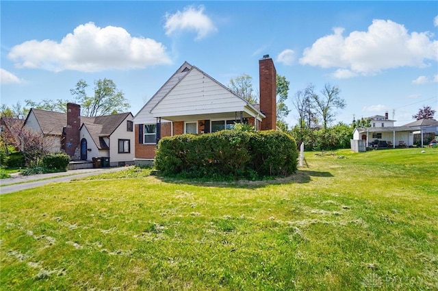 38 Homeview Dr, Harrison Twp, OH 45415 - rear view of house featuring a yard and brick siding