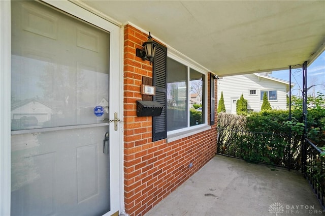 38 Homeview Dr, Harrison Twp, OH 45415 - property entrance with a porch and brick siding