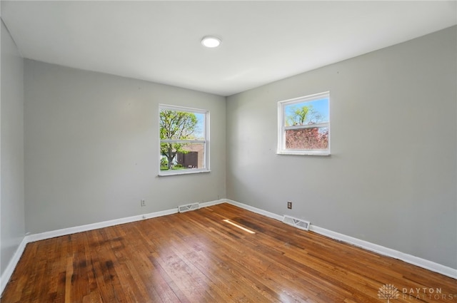 38 Homeview Dr, Harrison Twp, OH 45415 - unfurnished room with visible vents, baseboards, and hardwood / wood-style floors