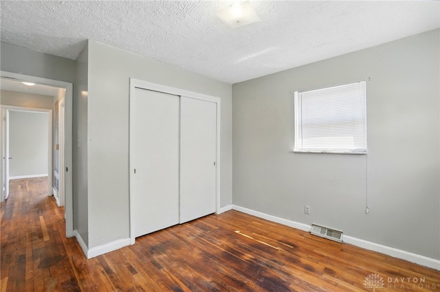 38 Homeview Dr, Harrison Twp, OH 45415 - unfurnished bedroom with a closet, baseboards, visible vents, and hardwood / wood-style floors