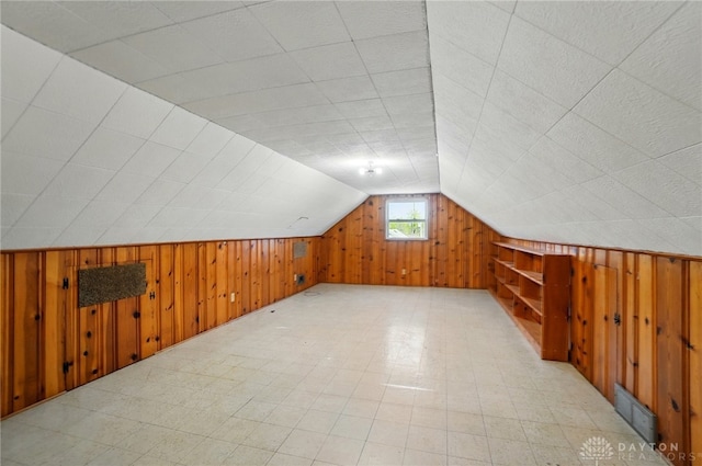 38 Homeview Dr, Harrison Twp, OH 45415 - bonus room featuring visible vents, wood walls, light floors, and vaulted ceiling
