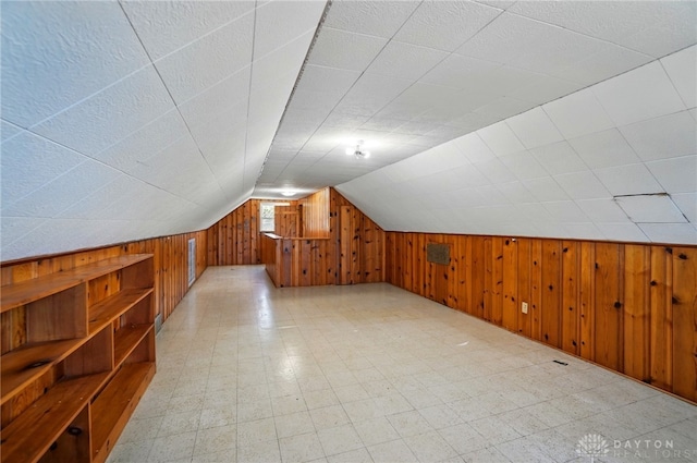 38 Homeview Dr, Harrison Twp, OH 45415 - bonus room with wood walls, vaulted ceiling, and light floors