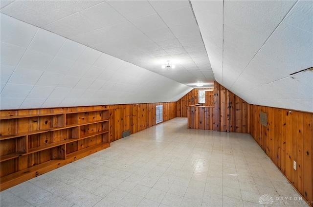 38 Homeview Dr, Harrison Twp, OH 45415 - additional living space featuring light floors, built in shelves, wooden walls, and vaulted ceiling