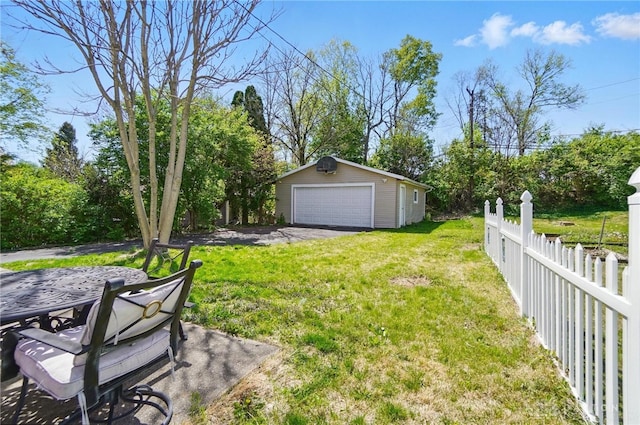 38 Homeview Dr, Harrison Twp, OH 45415 - view of yard featuring fence, an outbuilding, outdoor dining area, and a garage