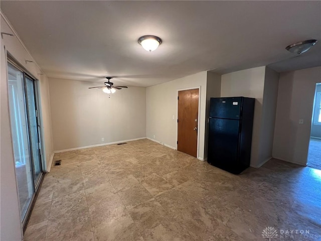 kitchen with baseboards, ceiling fan, freestanding refrigerator, and visible vents