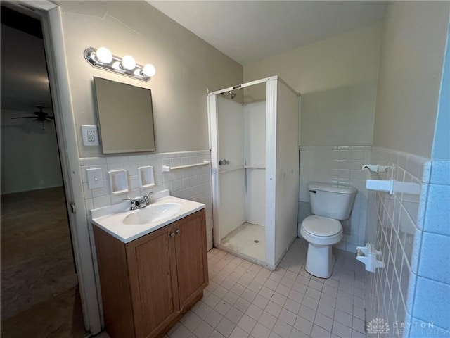 full bath featuring a stall shower, tile patterned floors, and tile walls