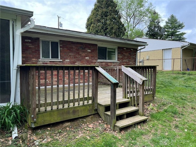 deck with a lawn and fence