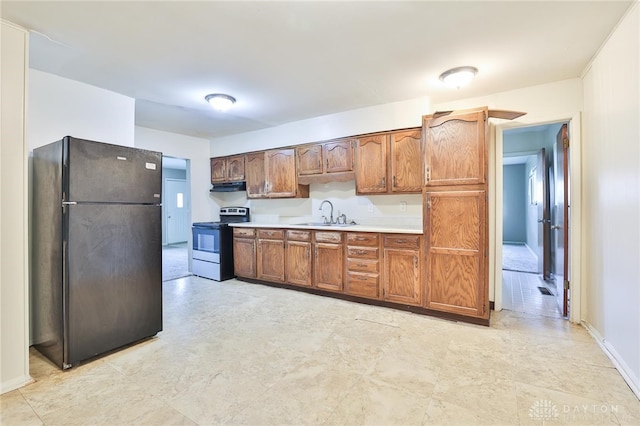 5565 Ehrling Rd, Cincinnati, OH 45227 - kitchen featuring freestanding refrigerator, stainless steel electric range oven, under cabinet range hood, a sink, and light countertops