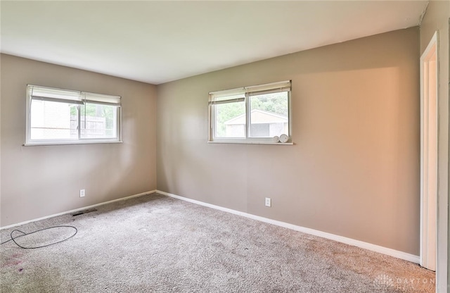 5565 Ehrling Rd, Cincinnati, OH 45227 - empty room featuring healthy amount of natural light, carpet flooring, and baseboards