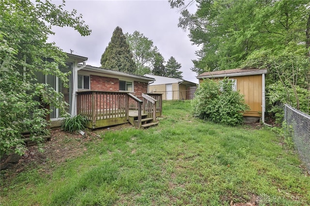 5565 Ehrling Rd, Cincinnati, OH 45227 - view of yard with a deck, a storage shed, and an outdoor structure