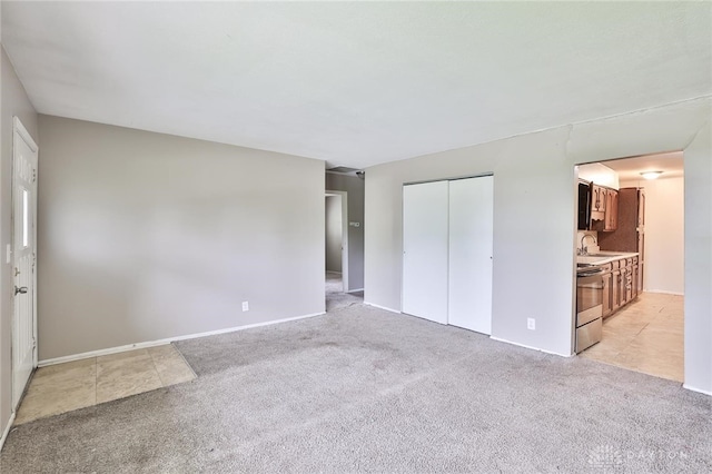 5565 Ehrling Rd, Cincinnati, OH 45227 - unfurnished bedroom featuring light colored carpet, a sink, a closet, and baseboards