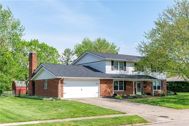 traditional home featuring fence, brick siding, a garage, a front yard, and concrete driveway