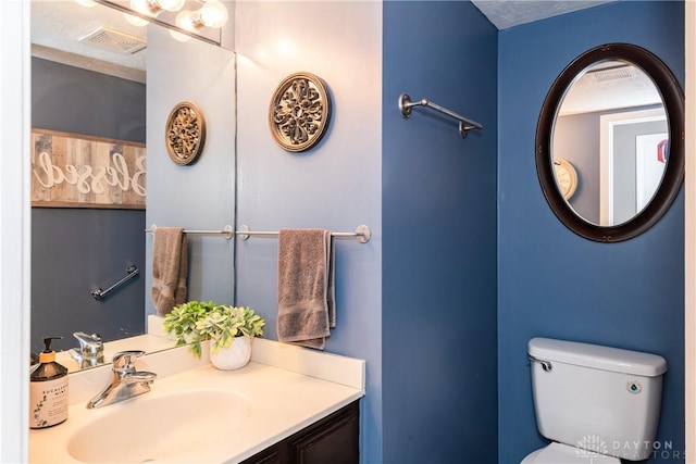 bathroom with visible vents, a sink, and toilet