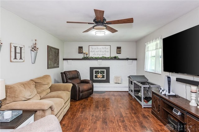 living room with a brick fireplace, wood finished floors, and ceiling fan