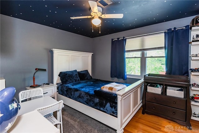 bedroom with visible vents and wood finished floors