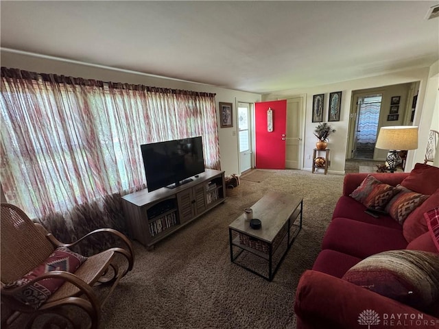living area with visible vents and carpet
