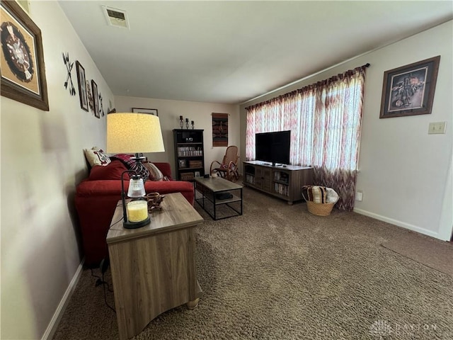 living area featuring visible vents, baseboards, and carpet floors