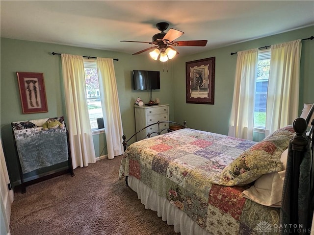 bedroom with a ceiling fan, multiple windows, and carpet