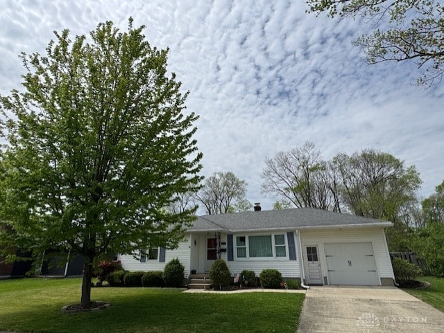 single story home with a garage, a front lawn, and driveway