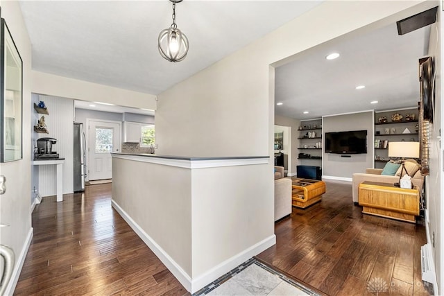 corridor featuring recessed lighting, baseboards, and dark wood-style floors