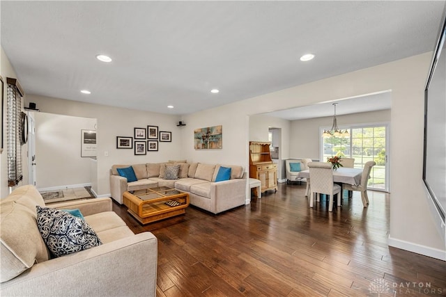 living room featuring recessed lighting, dark wood-style flooring, baseboards, and a chandelier