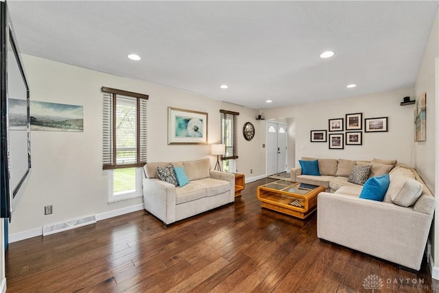 living area with recessed lighting, baseboards, hardwood / wood-style flooring, and visible vents