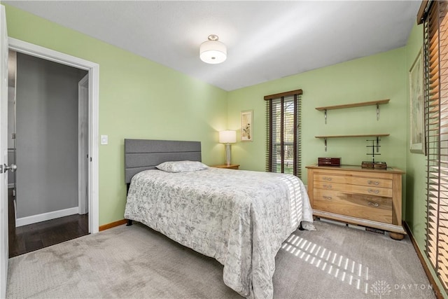 bedroom with carpet floors and baseboards