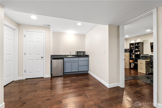 bar featuring wet bar, black microwave, dark wood-style floors, and dishwasher
