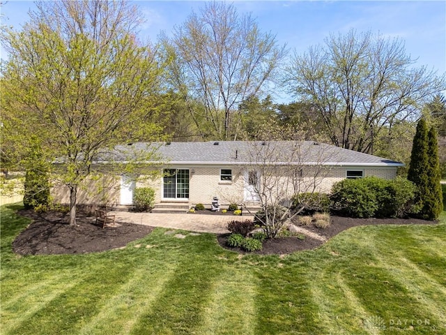 back of property with a lawn, a patio area, and entry steps