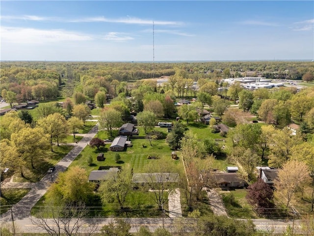 birds eye view of property featuring a wooded view
