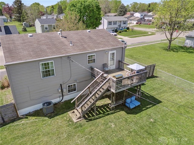 rear view of house featuring a residential view, central AC, a wooden deck, stairway, and a lawn