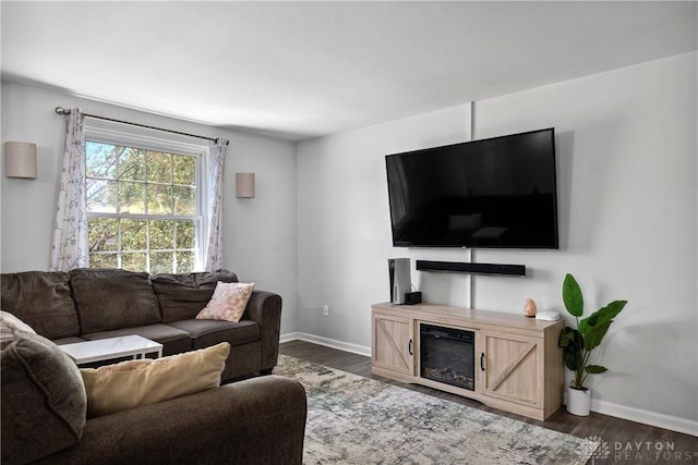 living area with baseboards and dark wood-style floors