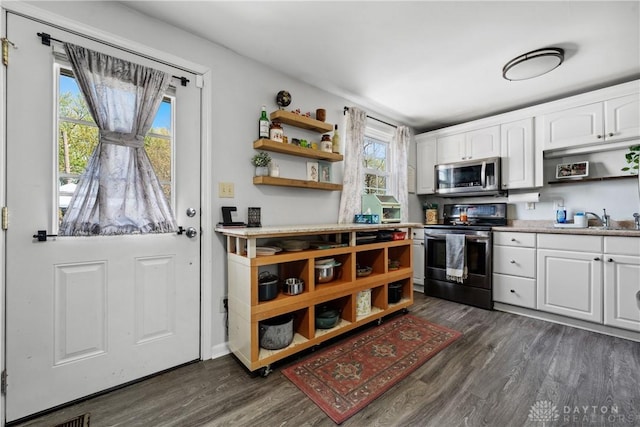 kitchen featuring stainless steel appliances, open shelves, dark wood-style floors, and white cabinetry