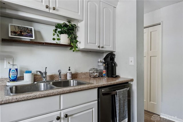 kitchen featuring open shelves, dark wood-type flooring, white cabinets, a sink, and dishwasher