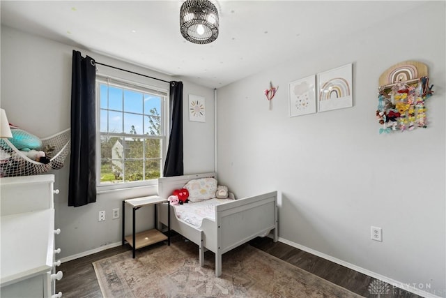 bedroom featuring baseboards and wood finished floors