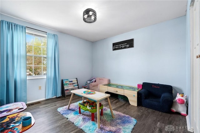 rec room featuring visible vents, baseboards, and wood finished floors