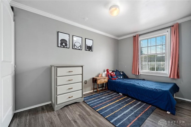 bedroom featuring baseboards, ornamental molding, and wood finished floors