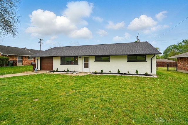 single story home with a garage, a front lawn, fence, roof with shingles, and concrete driveway