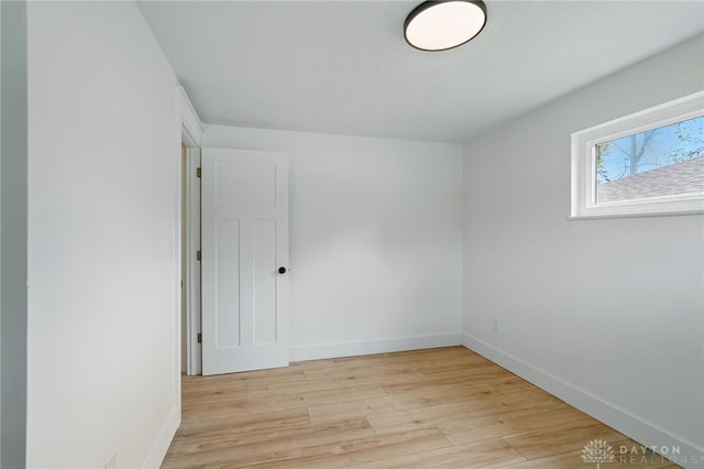 empty room featuring light wood-style floors and baseboards