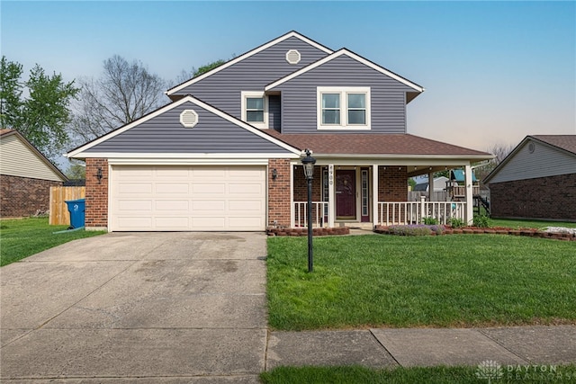 traditional home featuring brick siding, a garage, a porch, a front yard, and driveway