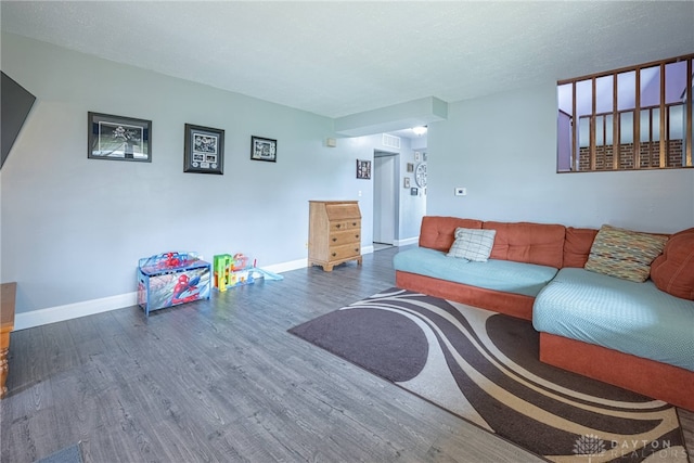 living room with baseboards and wood finished floors