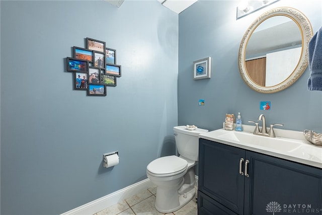bathroom with vanity, baseboards, and toilet