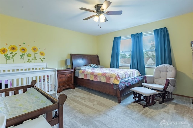 bedroom with ceiling fan and light colored carpet