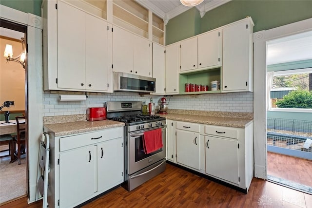 kitchen featuring crown molding, light countertops, dark wood-style flooring, and stainless steel appliances